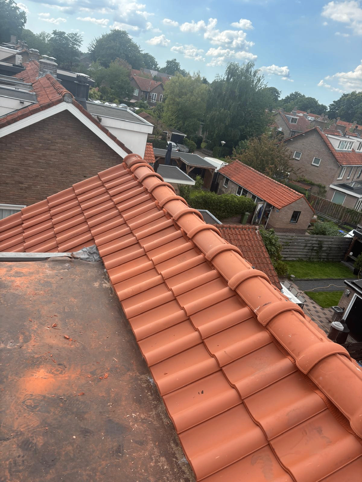 Nieuwe nokvorst en zijaansluiting op pannendak in Sliedrecht